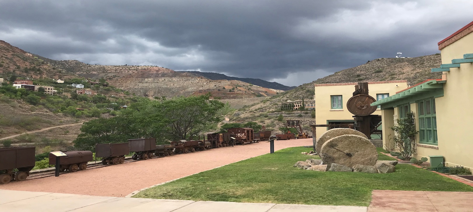 An outside view of the Douglas Mansion and some mining equipment at Jerome State Historic Park