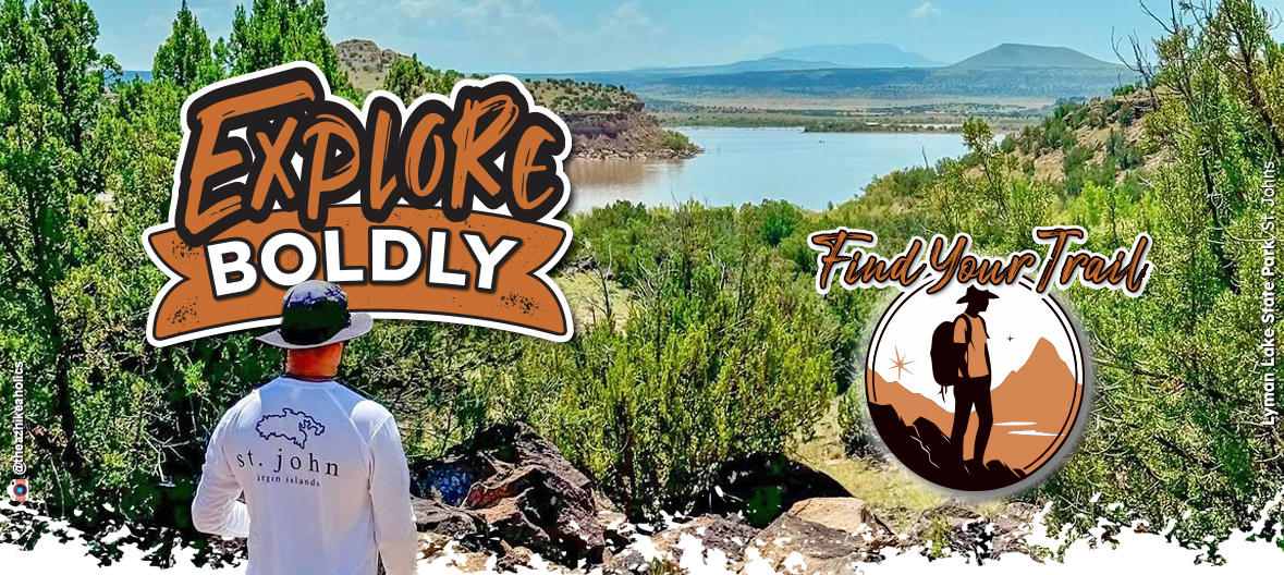 A man hikes the trail overlooking Lyman Lake. The text overlay says "Explore Boldly! Find Your Trail!"