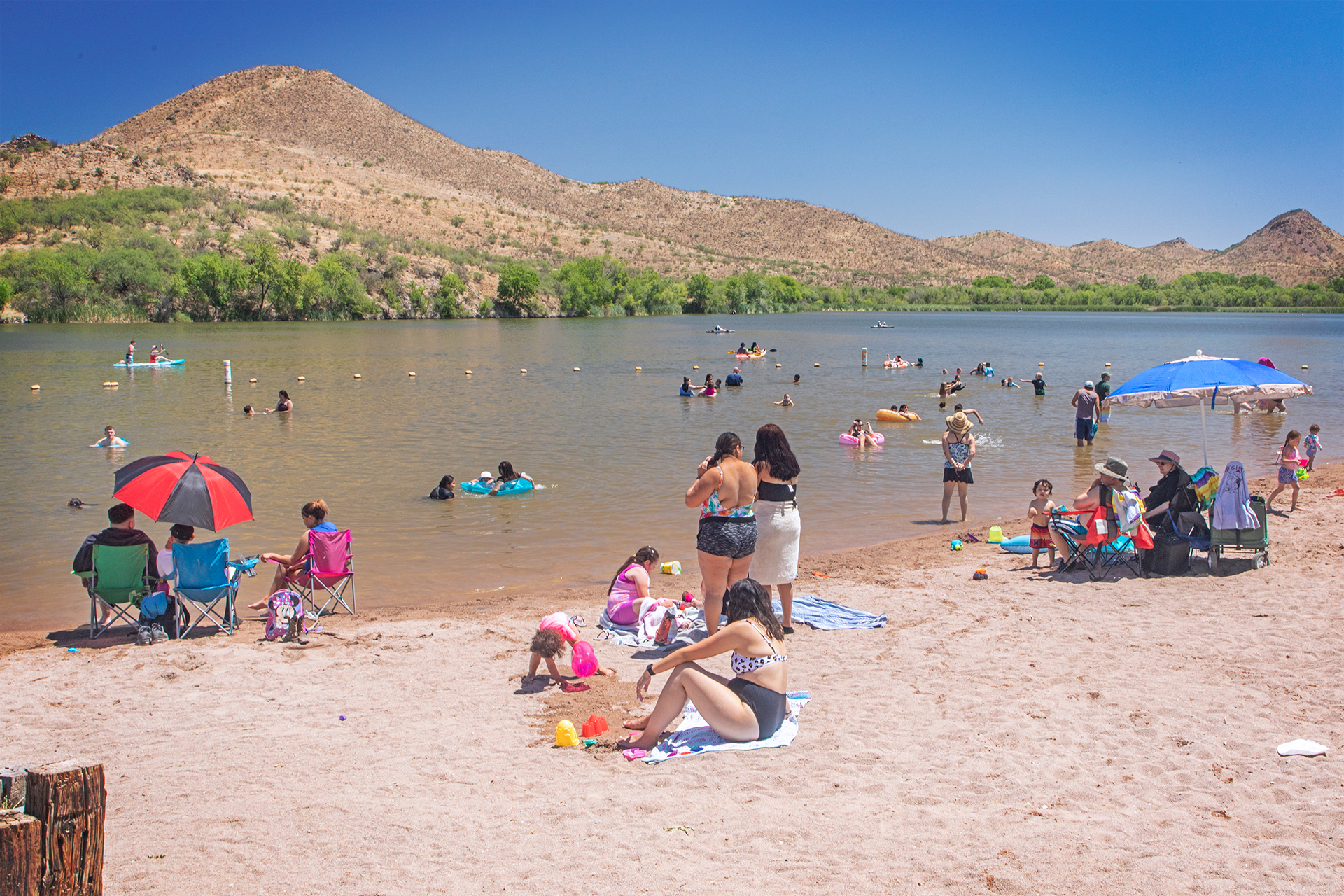 People enjoy the white sand beach at Patagonia Lake State Park