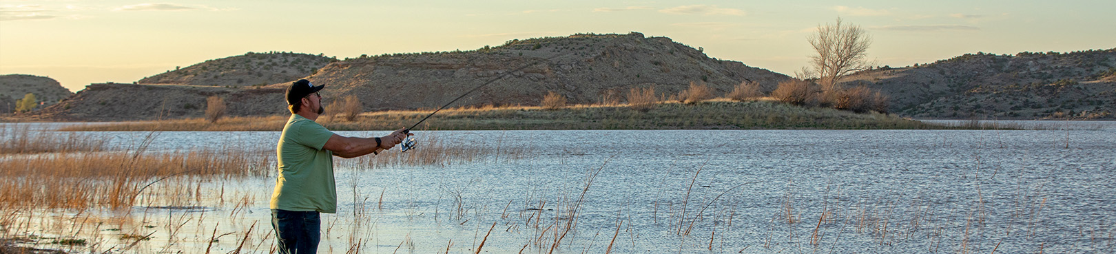 An angler takes a cast from shore into the windblown high desert lake.