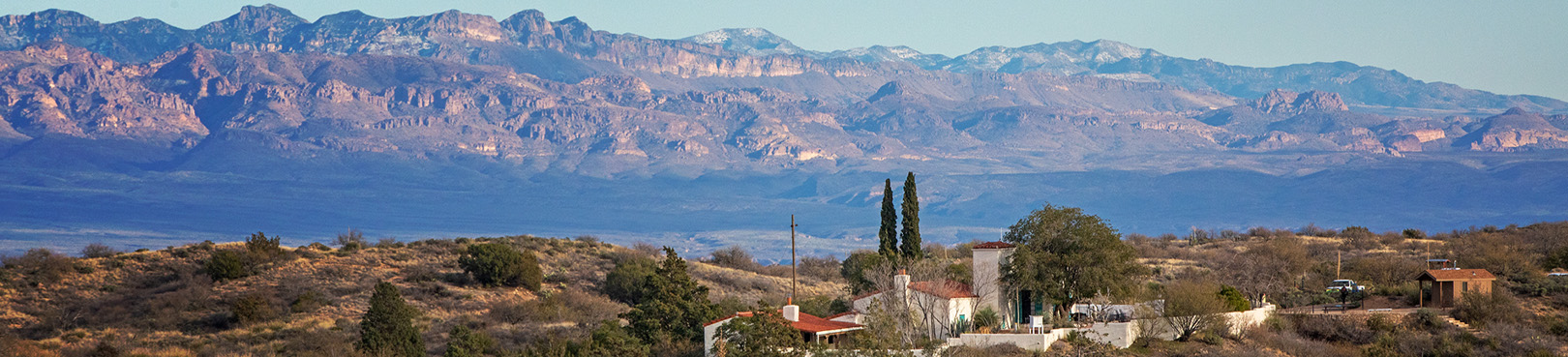 An overview of Oracle State Park, with the Kannally Ranch House in the center and Galiuro Mountains in the distance