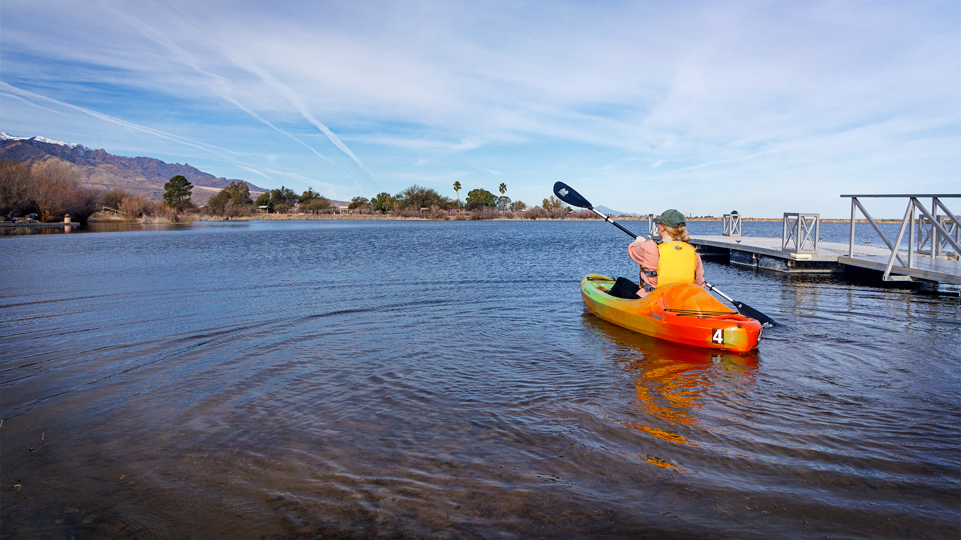 A woman kayaks away from the dock at Roper Lake State Park