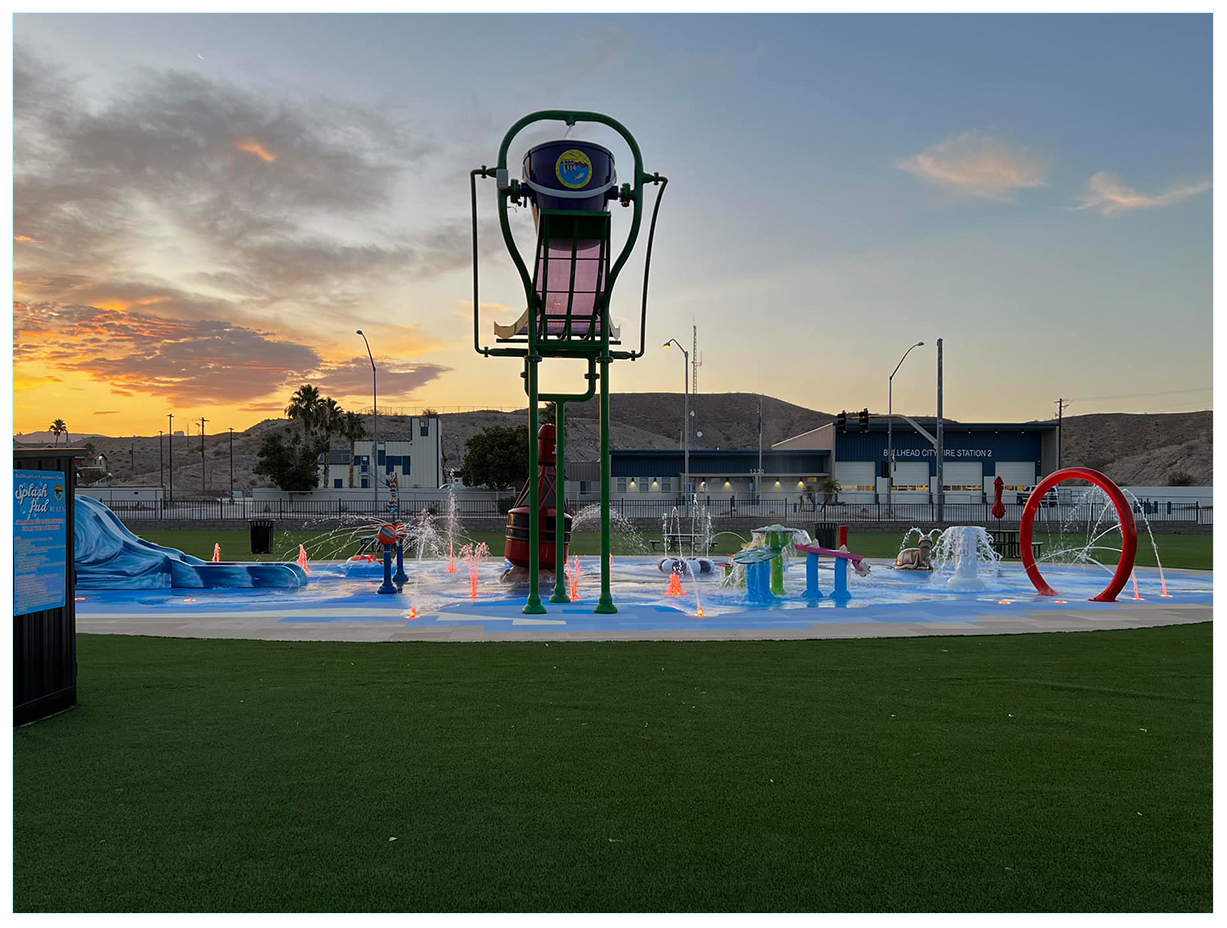 Photo of a splash pad in a park at sunset. This project was completed with an AZ Sate Parks grant.