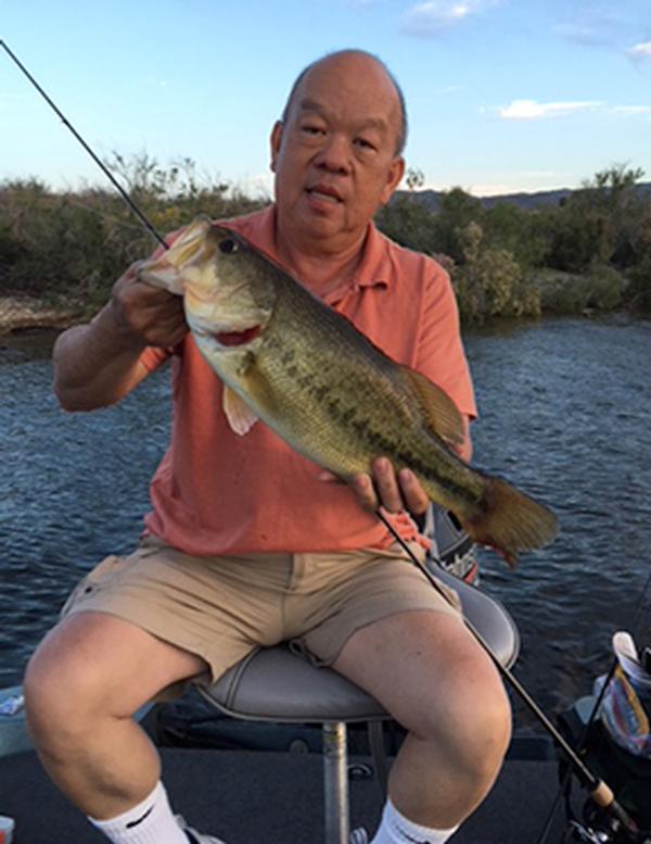  A man holds a five pound Alamo Lake State Park largemouth. 