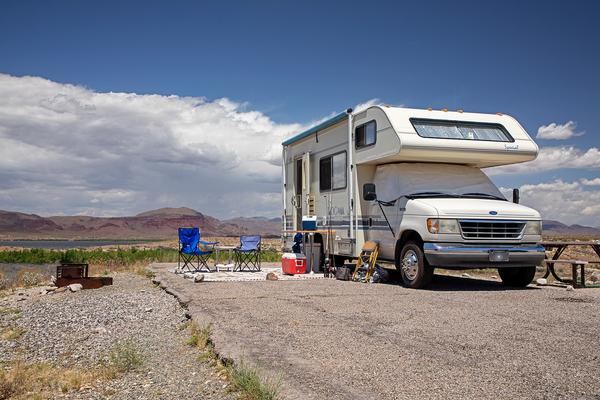 An RV set up with seating area at the Alamo Lake campground
