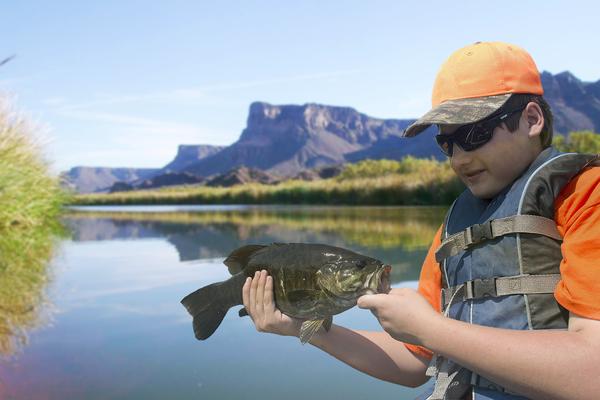 An angler holds a Colorado River Smallmouth