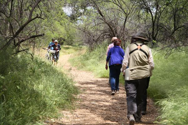 Two hikers head toward two cyclists coming the opposite direction on a trail at the park