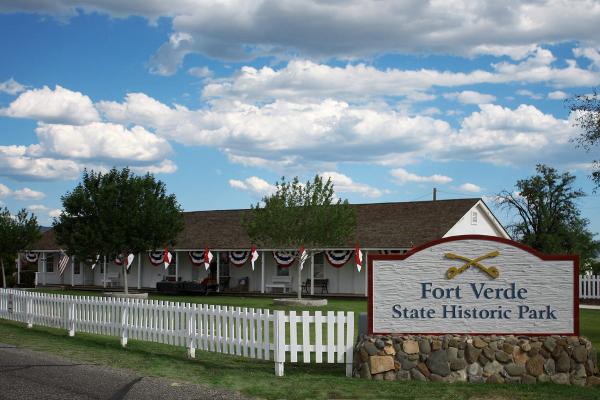A view of the park sign and building housing the museum at Fort Verde State Historic Park in central Arizona