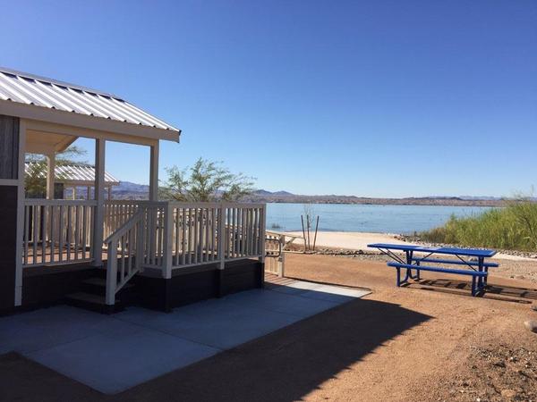The cabins on the white sand beach with the Colorado River lapping at the shore.