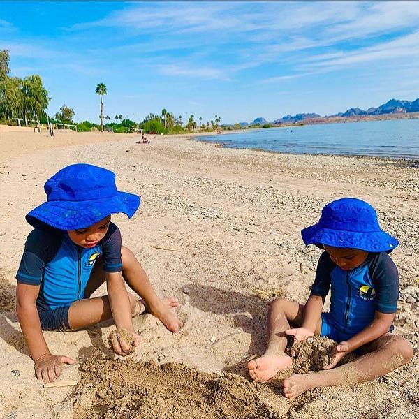Two children play in the white sand on one of the Lake Havasu beaches