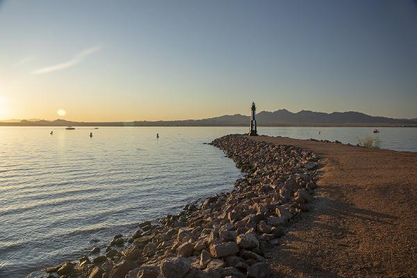 A view of the lighthouse on an inlet in Lake Havasu State Park, at sunset.