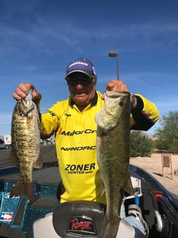 A Great Day At Lake Havasu! Angler holding trophy largemouth and smallmouth in a boat.