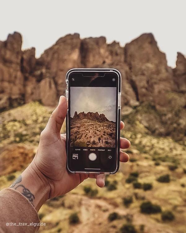 A phone snaps a picture of the Superstition Mountains