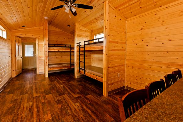 The interior of one of the rental cabins at the park, showing bunk beds and a seating area