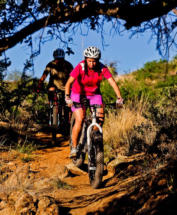 Two mountain bikers on a trail at Oracle State Park