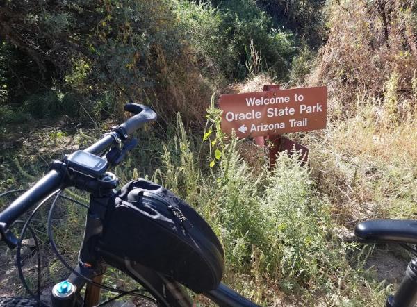 A mountain bike near signage for the Arizona Trail at Oracle