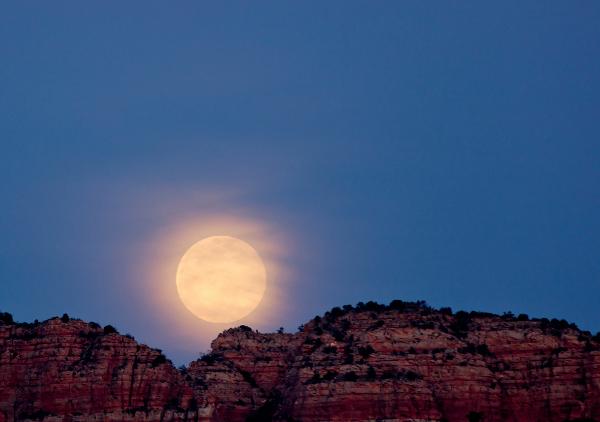 A full moon rises over the mountains during a Moonlight Hike at Red Rock State Park in Sedona