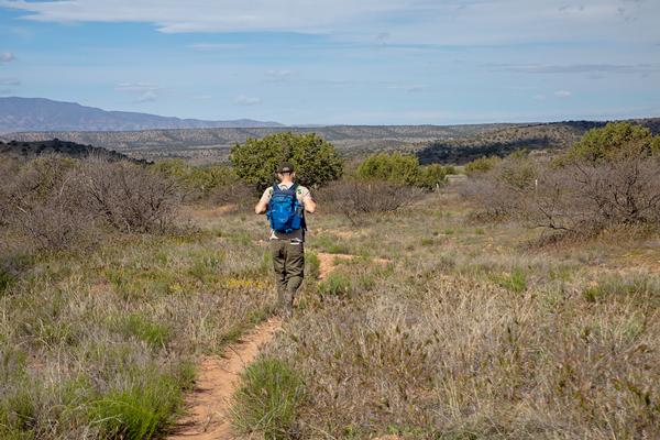 A man hiking the Lime Kiln Trail from Cottonwood to Sedona