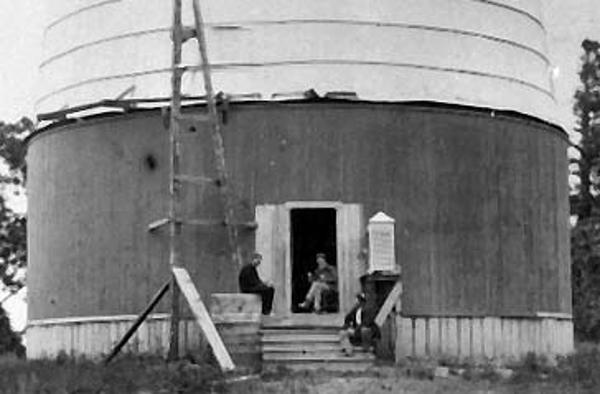 A.E. Douglass sitting in the doorway of the dome for the 24-inch Alvan Clark refracting telescope at Lowell Observatory in Flagstaff, Arizona, circa 1897. Photo courtesy of Lowell Observatory Archives.