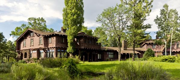 The expansive Riordan Mansion State Historic Park, surrounded by lush Flagstaff greenery.