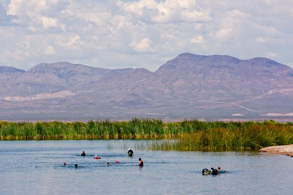 Swimmers in the water at Roper Lake State Park, with Mount Graham in the background