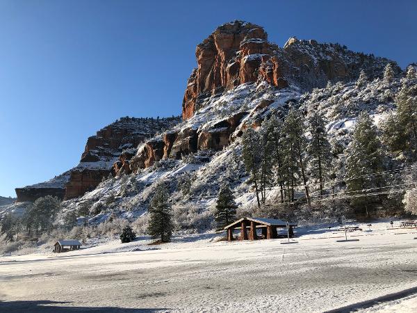 Snow covers the mountains and ground at Slide Rock State Park