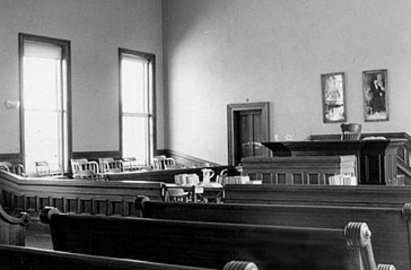 A black and white photo of Tombstone Courthouse courtroom
