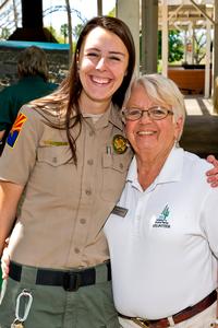Volunteer and ranger pose for a pic at an event.