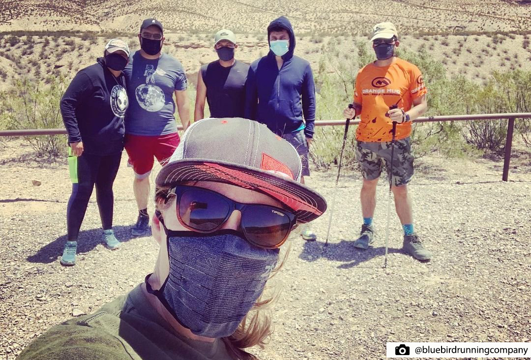 Group of hikers wearing masks on a desert trail in Arizona.