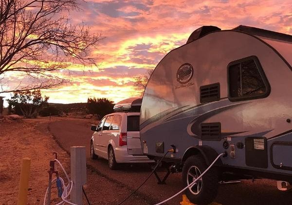 A sunset in front of an RV ready for camping at Lyman Lake in St. Johns, Arizona