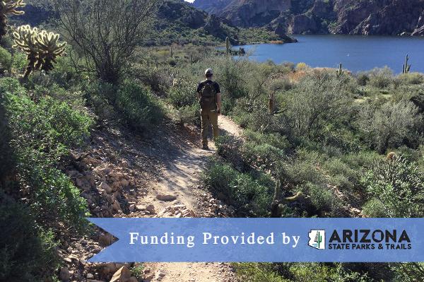 Man walking on a desert trail along the Colorado River. This trail was built with an AZ State Parks grant.