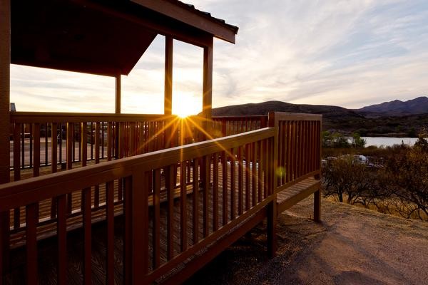 The sun sets in a view from the porch of a Southern Arizona Cabin Rental at Patagonia Lake