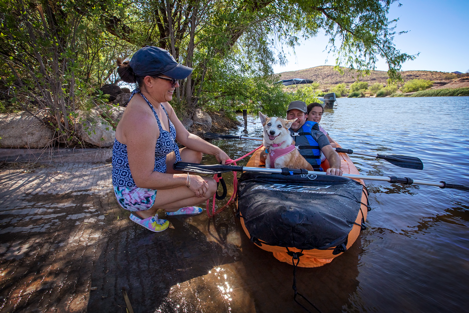 A woman loads a dog and her child into a kayak at Patagonia Lake State Park