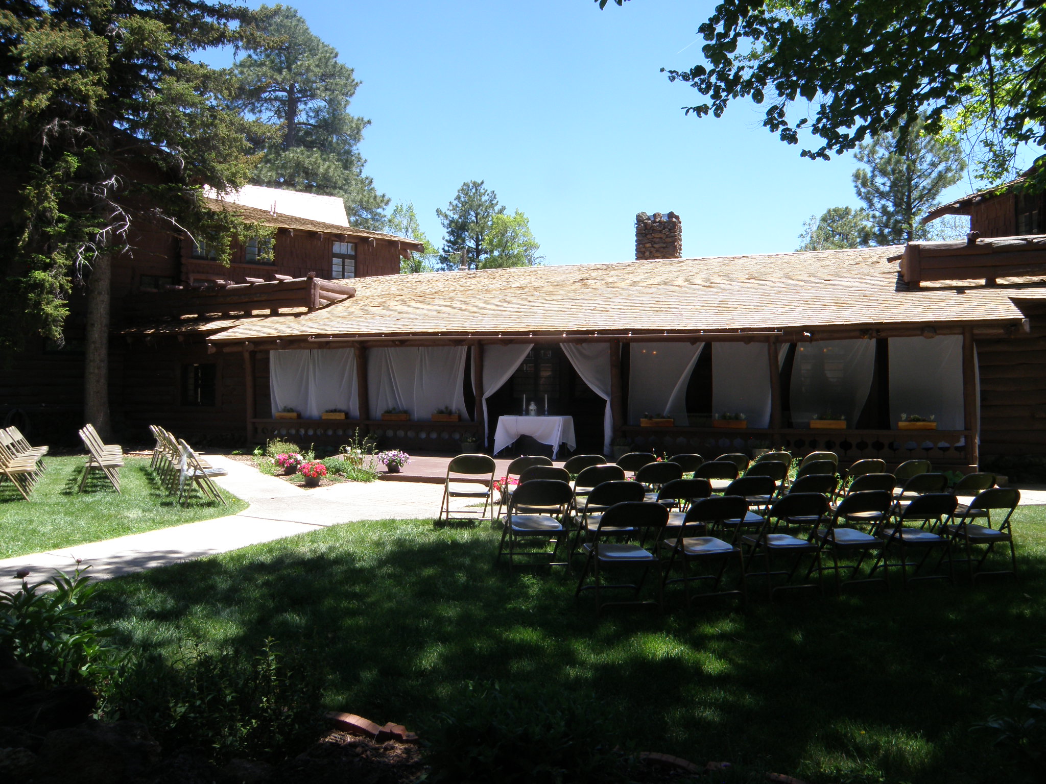 Curtains hung along the porch of Riordan Mansion, setting a backdrop for a wedding