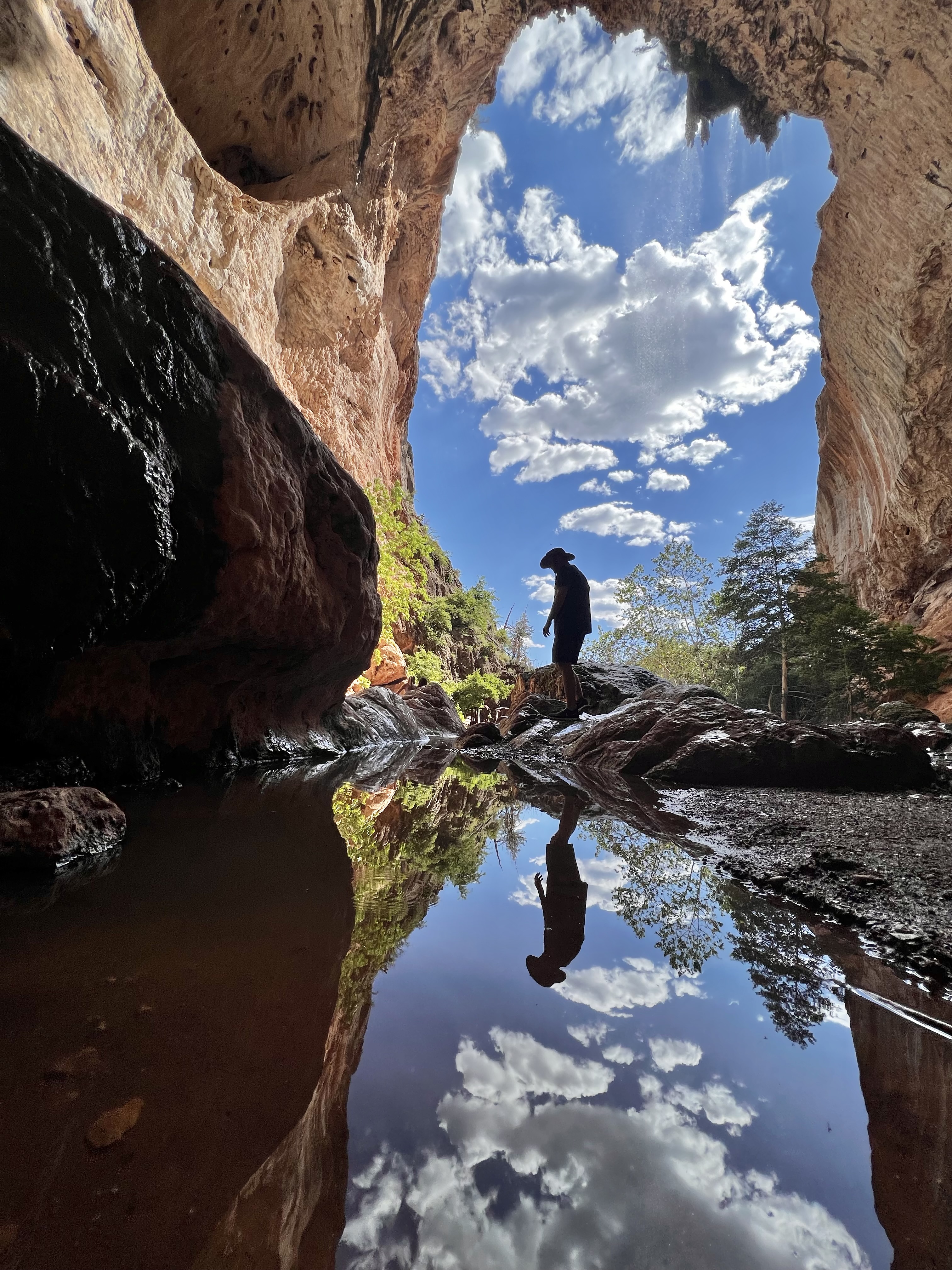 A man stands under the natural bridge at Tonto Natural Bridge State Park in the grand prize winning photo