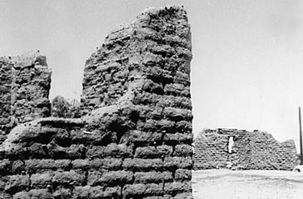 A black and white photo of a crumbling adobe wall at the Tubac Presidio