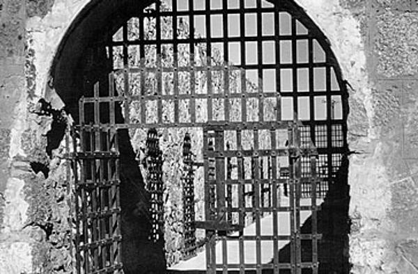 A black and white photo of the prison bars at Yuma Territorial Prison