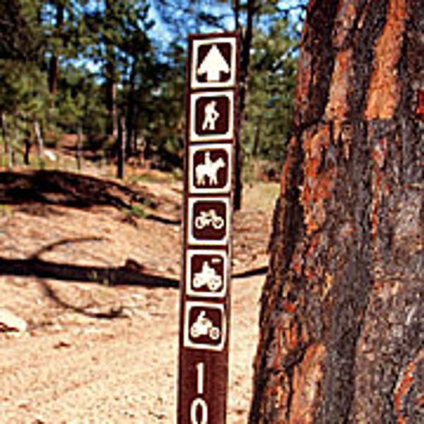 Vertical trail sign that denotes the types of trail use thats appropriate.