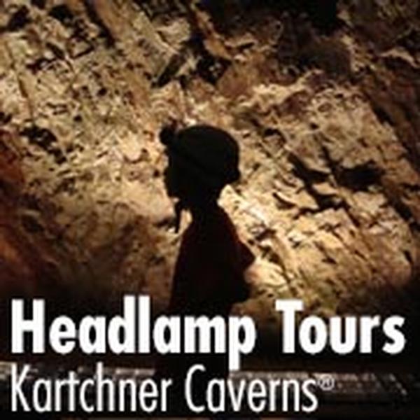Headlamp Tours at Kartchner Caverns: The shadow of a young boy is cast on the wall of Kartchner Caverns.