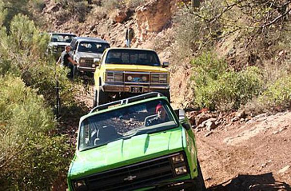 Jeeps drive down a mountainside