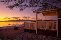 Arizona glamping at Lake Havasu State Park at sunset on the lakeshore