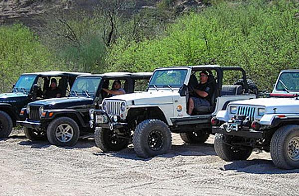A line of jeeps are prepared for an off-road adventure