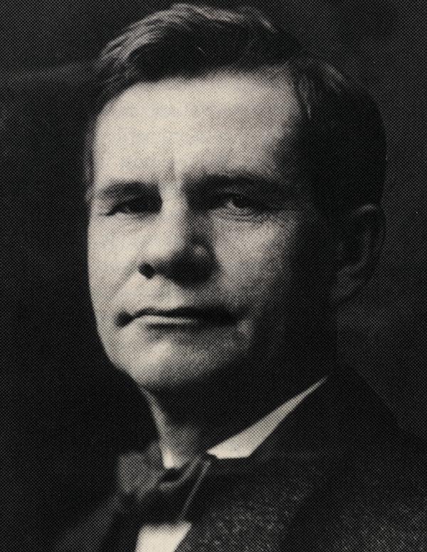 A historic black and white photograph of Gustav Stickley
