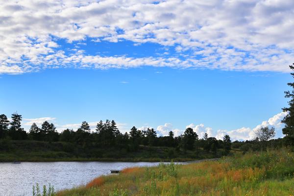 Summer camping at Fool Hollow Lake Recreation Area amid partly cloudy northern Arizona skies
